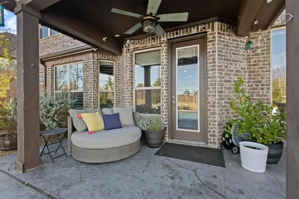 a view of a patio with couches and potted plants