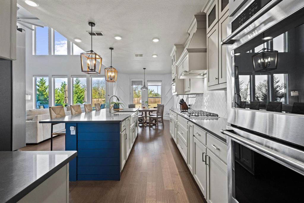 13798 Fernando Road Frisco, TX 75035 - Photo 10 of 39 a kitchen with stainless steel appliances granite countertop lots of counter top space and wooden floor
