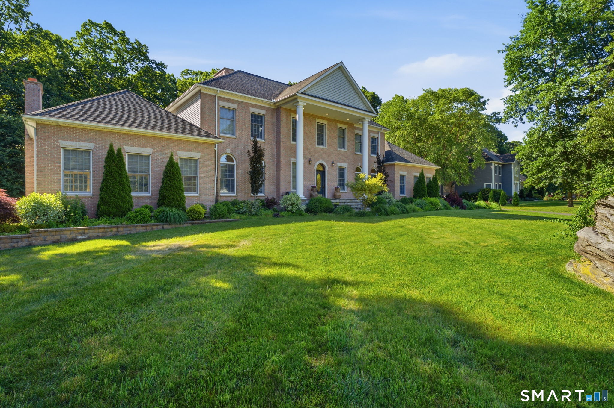 52 Country Club Road Bolton, CT 06043 - Photo 3 of 36 a front view of a house with a yard and trees