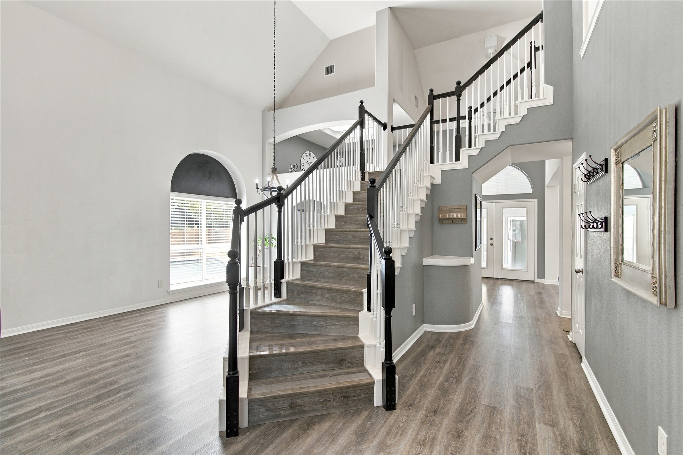 910 Point Run Drive Pflugerville, TX 78660 - Photo 10 of 39 An elegant staircase rises gracefully within a towering foyer featuring durable wood-look flooring.