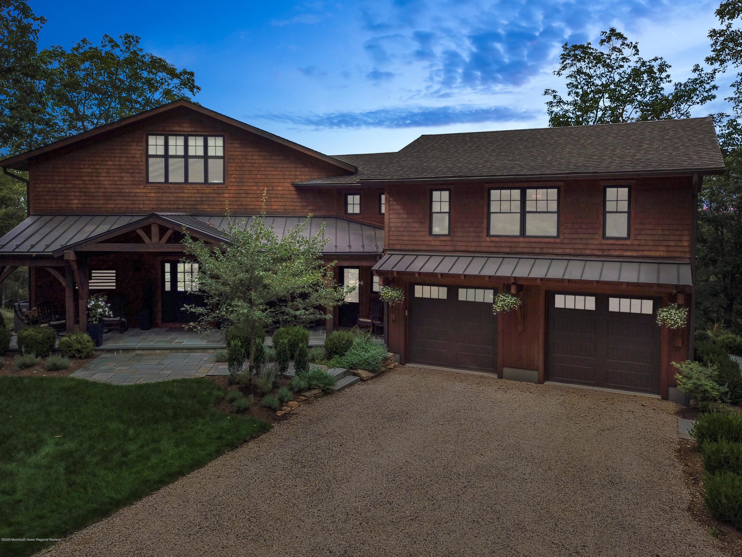a front view of a house with a garden
