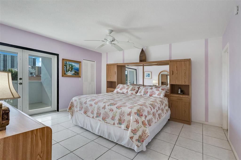 320 South Surf Road, Unit 304 Hollywood, FL 33019 - Photo 17 of 20 a bedroom with a large bed and a chandelier