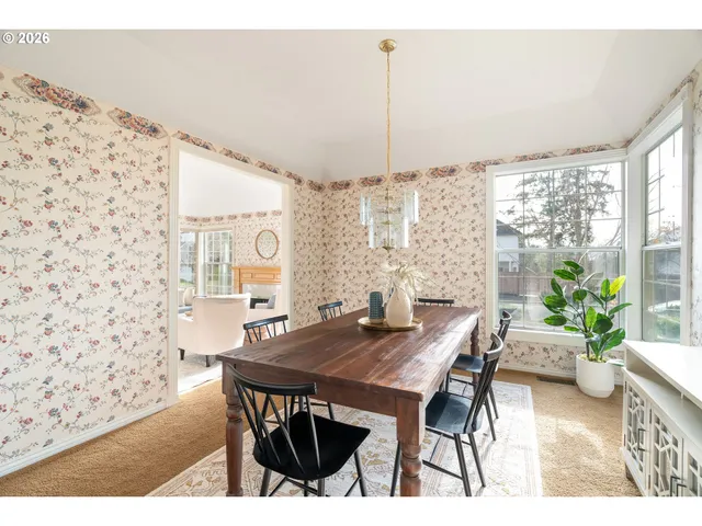 a view of a dining room with furniture and window