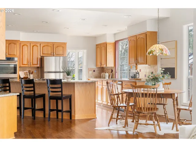 a dining room with furniture and wooden floor
