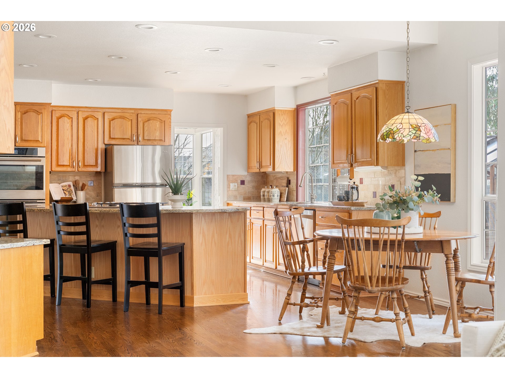 9985 Southwest 141st Avenue Beaverton, OR 97008 - Photo 15 of 47 a dining room with furniture and wooden floor