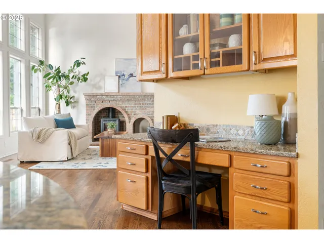 a living room with furniture a fireplace and a potted plant