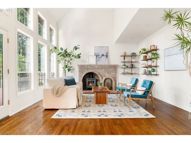 a living room with furniture a fireplace and a potted plant