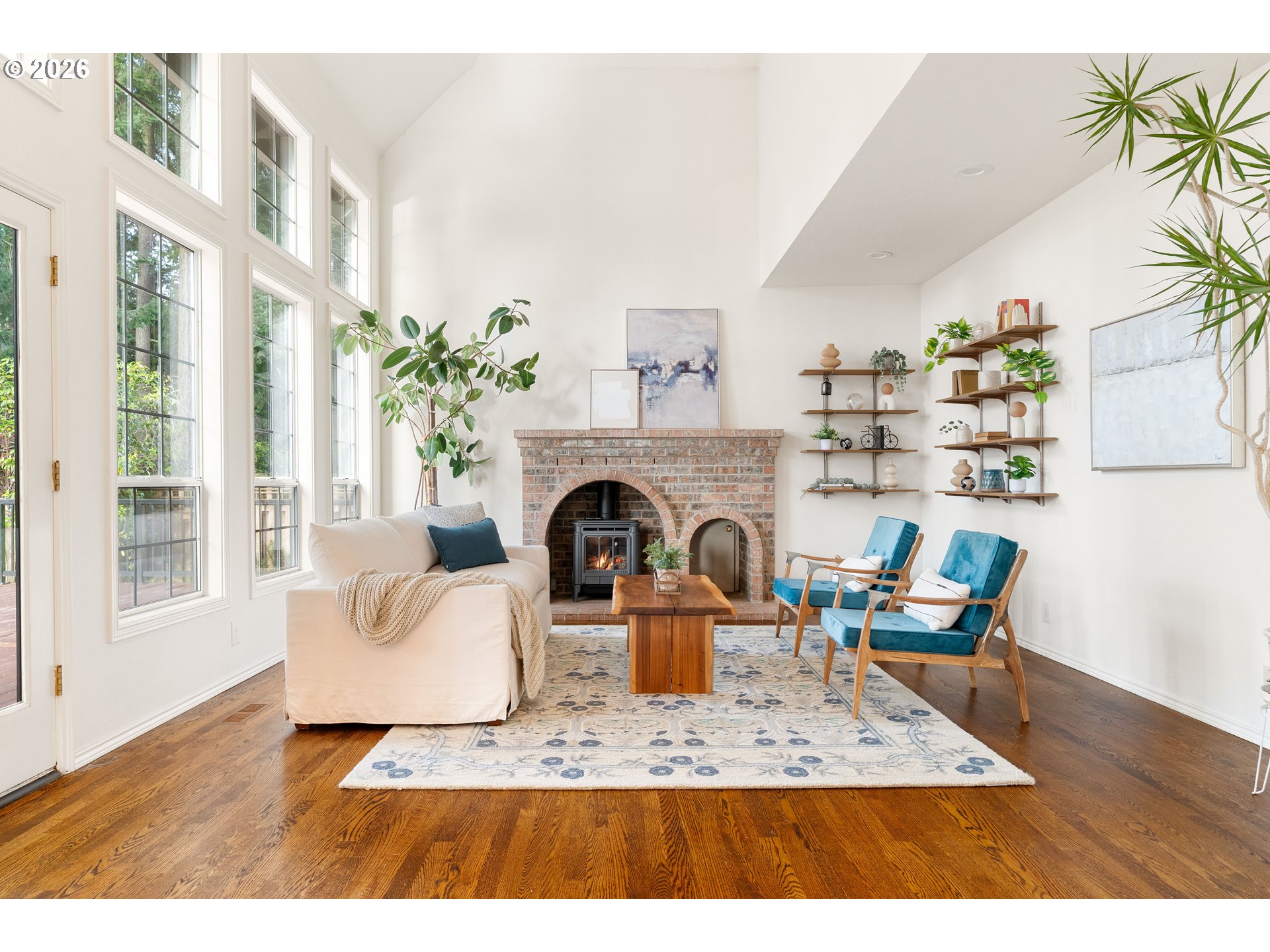 9985 Southwest 141st Avenue Beaverton, OR 97008 - Photo 23 of 47 a living room with furniture a fireplace and a potted plant