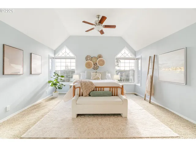 a bedroom with a bed and a large window