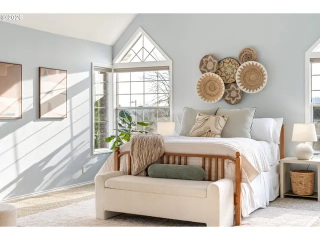 a bedroom with a large bed and a window