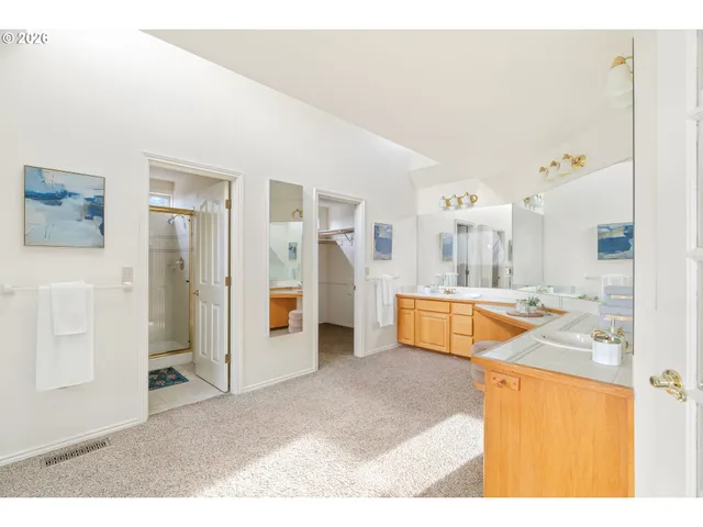 a large white kitchen with a large window