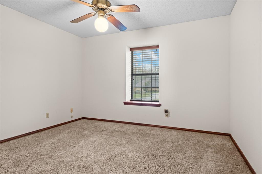 5840 Crystal Drive Midlothian, TX 76065 - Photo 18 of 36 an empty room with a window and a fan