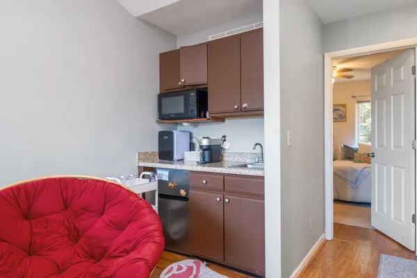 a kitchen with stainless steel appliances a sink cabinets and wooden floor