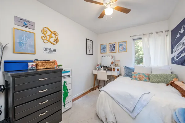 a bedroom with a bed and a chandelier