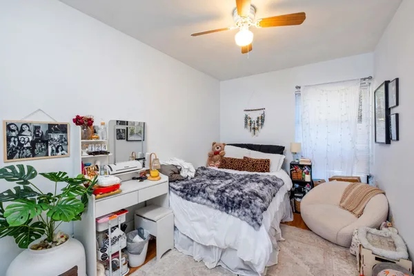 a bedroom that has a bed and a chair in it