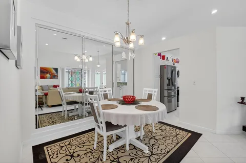 a kitchen with granite countertop cabinets a sink and white appliances