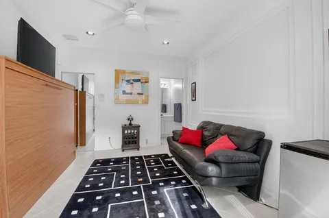 a view of a building with a yard and potted plants