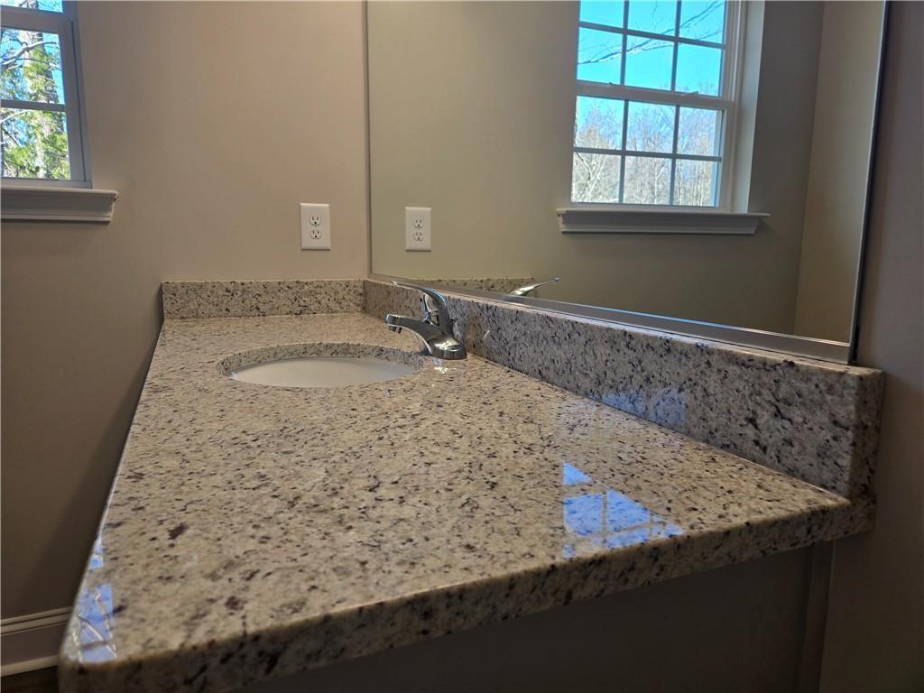 2978 Cannon Bridge Road Demorest, GA 30535 - Photo 31 of 36 a bathroom with a granite countertop sink and a mirror