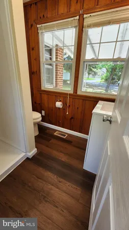 a view of a room with wooden floor and a window