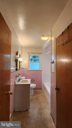 a room with kitchen island a sink a stove and a refrigerator