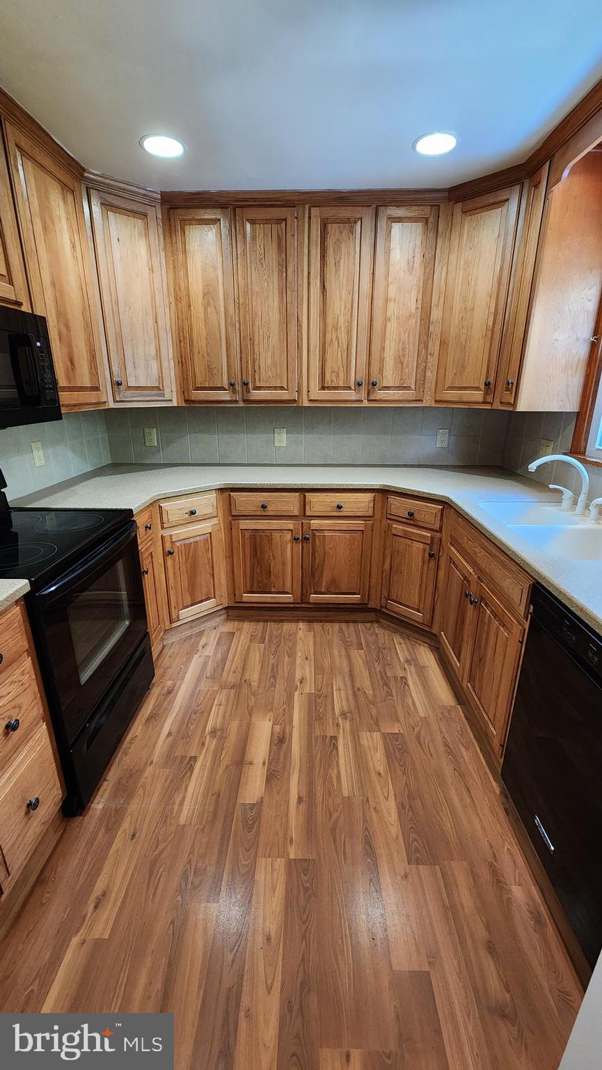 117 Girard Road North Glassboro, NJ 08028 - Photo 6 of 17 a view of a kitchen with wooden floors and a sink