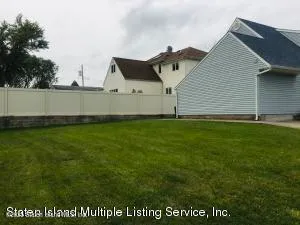 a view of a house with a yard and sitting area