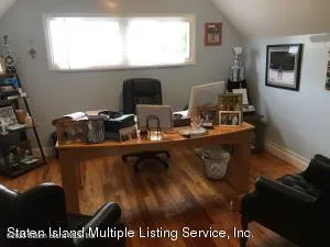 a living room with furniture a window and a flat screen tv