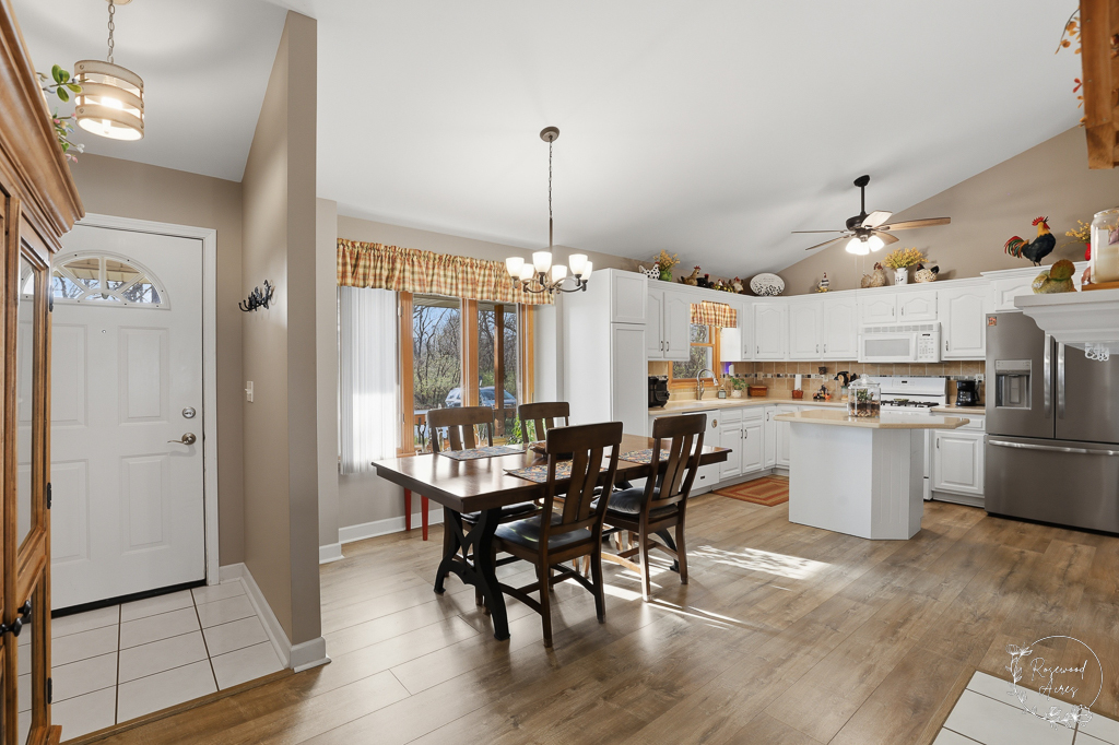 2853 Forsythia Lane St. Anne, IL 60964 - Photo 4 of 31 a kitchen with appliances cabinets dining table and chairs