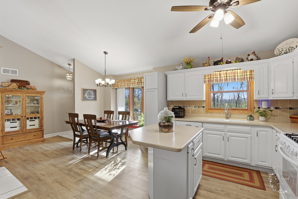2853 Forsythia Lane St. Anne, IL 60964 - Photo 8 of 31 a kitchen with a table chairs and white cabinets