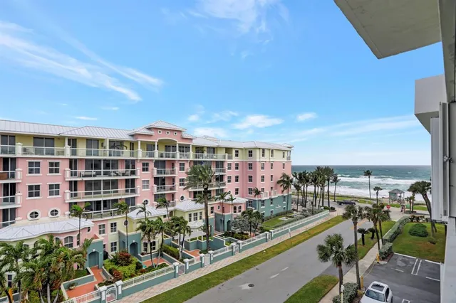 a living room with furniture a flat screen tv and a kitchen