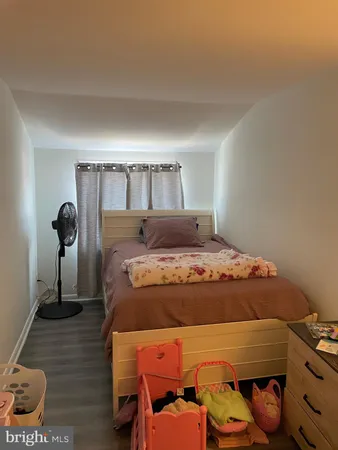 a bedroom with a bed and a mirror