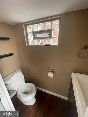 a bathroom with a toilet a sink and a window