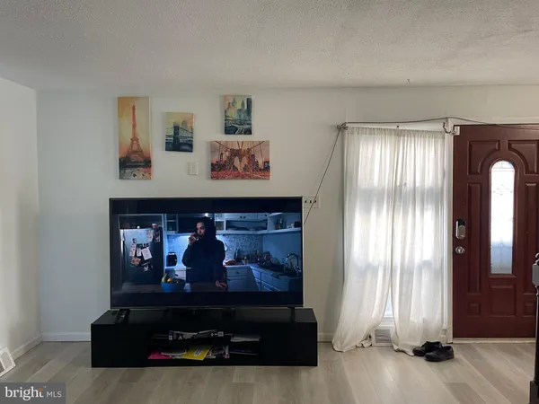 a living room with furniture and paintings on the wall