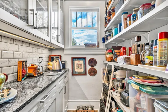 a view of a dining room with furniture large windows and wooden floor