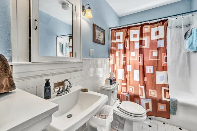 a view of a dining room with furniture and a book shelf