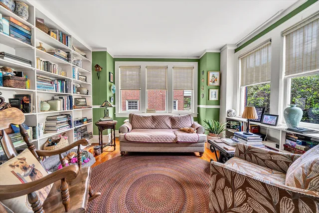 a dining room with wooden floor a chandelier a wooden table and chairs