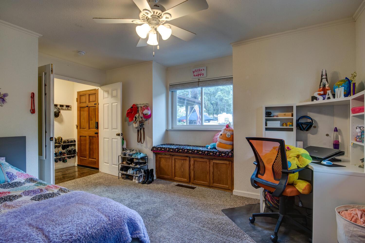 23832 Old Madrone Road Pioneer, CA 95666 - Photo 11 of 48 a bedroom with bed and a chandelier