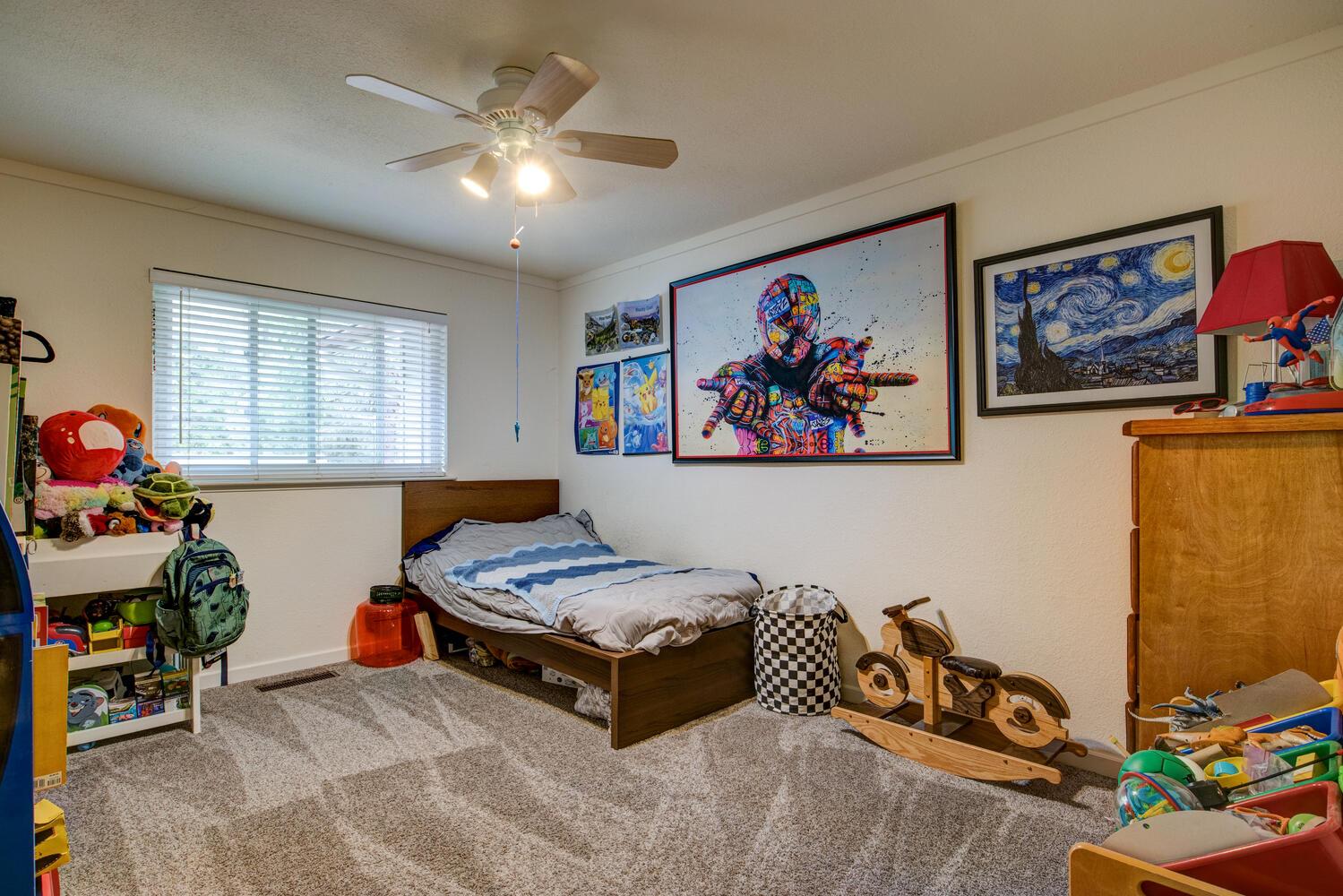 23832 Old Madrone Road Pioneer, CA 95666 - Photo 12 of 48 a bedroom with bed and a chandelier