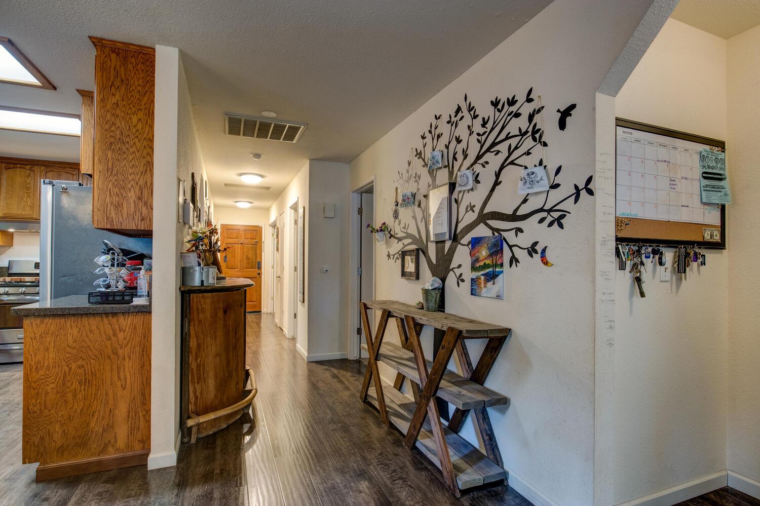 23832 Old Madrone Road Pioneer, CA 95666 - Photo 14 of 48 a view of a hallway with wooden floor and dining room view