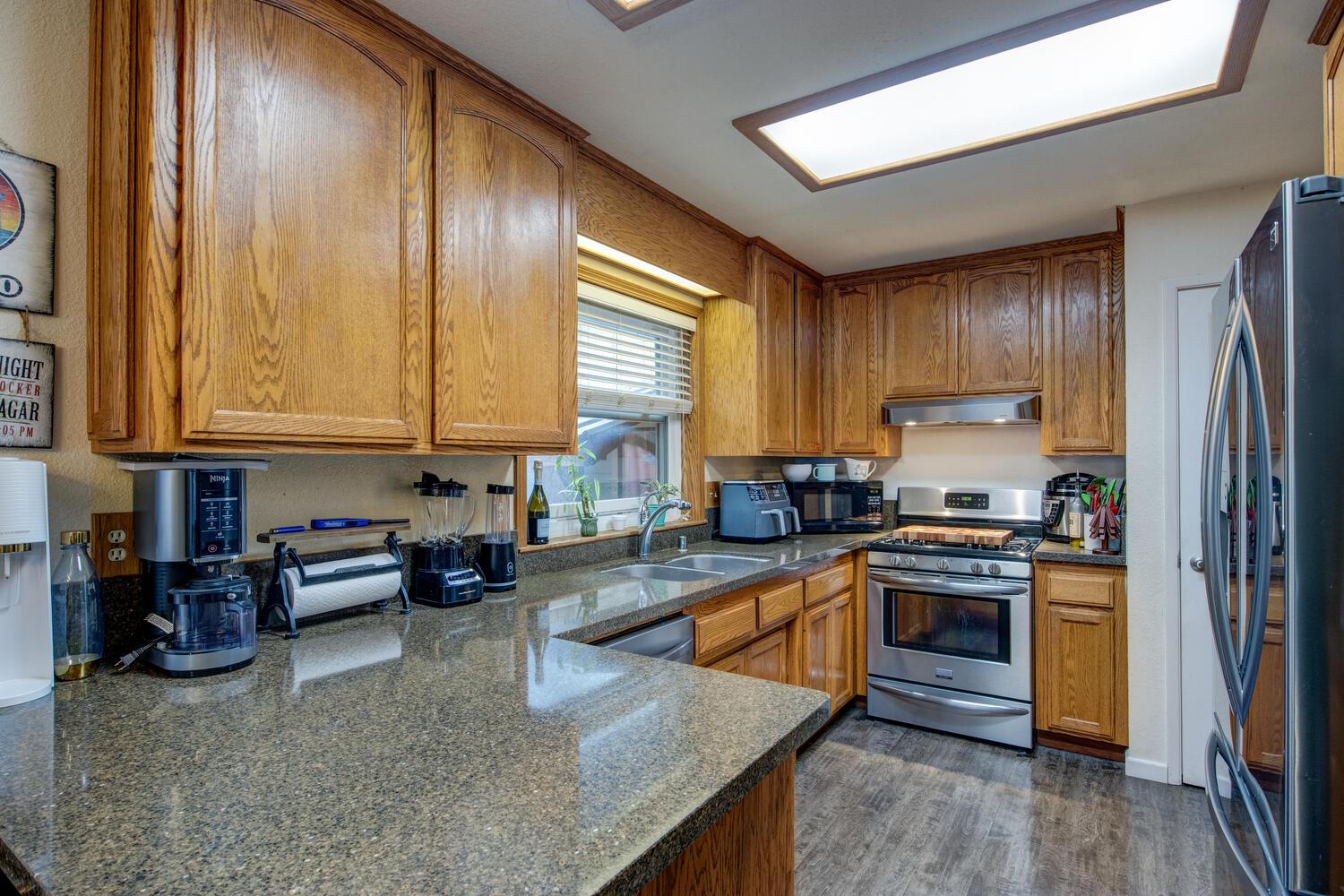 23832 Old Madrone Road Pioneer, CA 95666 - Photo 17 of 48 a kitchen with stainless steel appliances granite countertop a stove a sink and a refrigerator