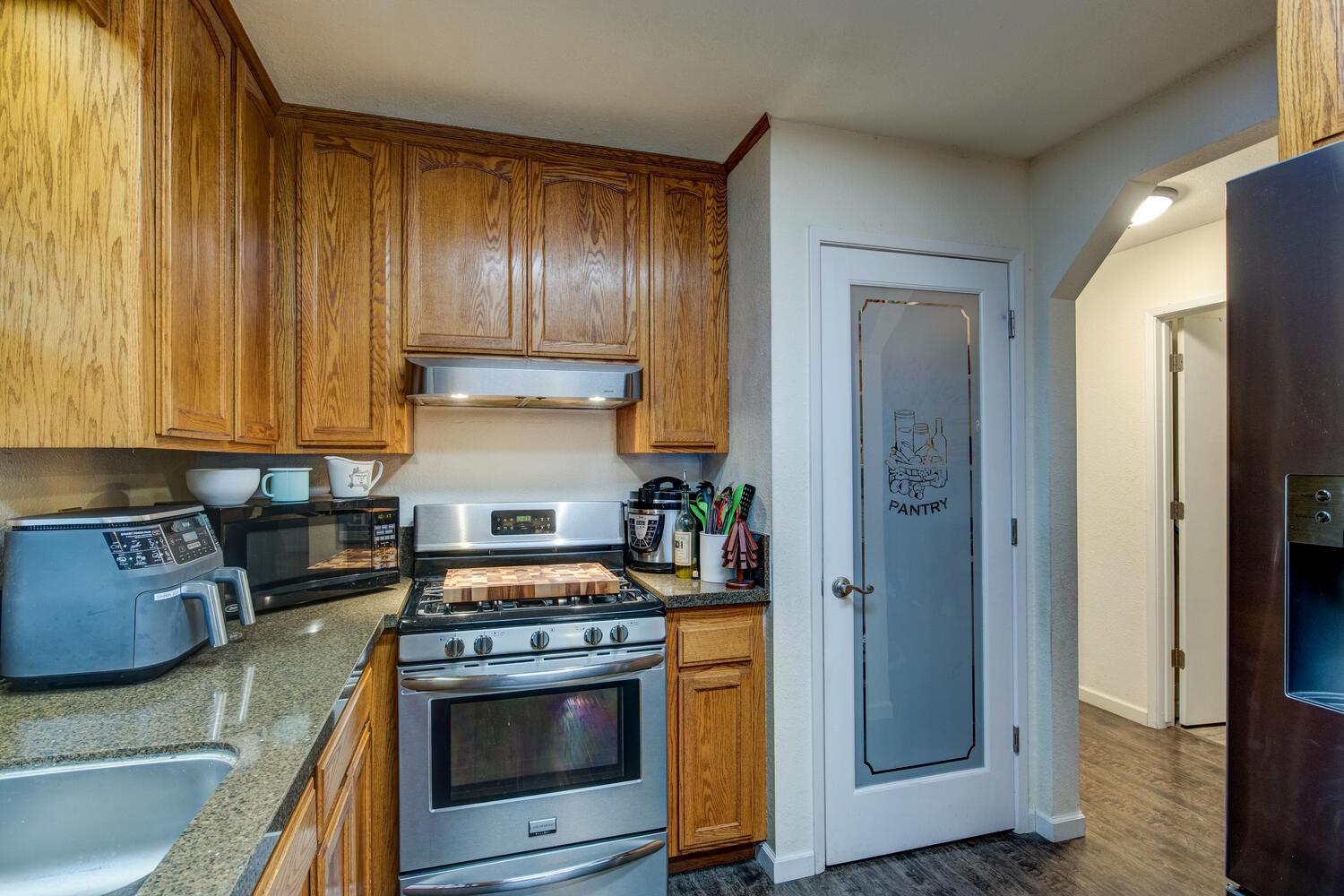 23832 Old Madrone Road Pioneer, CA 95666 - Photo 18 of 48 a kitchen with granite countertop wooden cabinets and stainless steel appliances