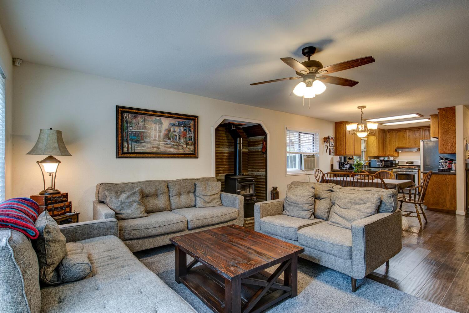 23832 Old Madrone Road Pioneer, CA 95666 - Photo 22 of 48 a living room with furniture a ceiling fan and a fireplace
