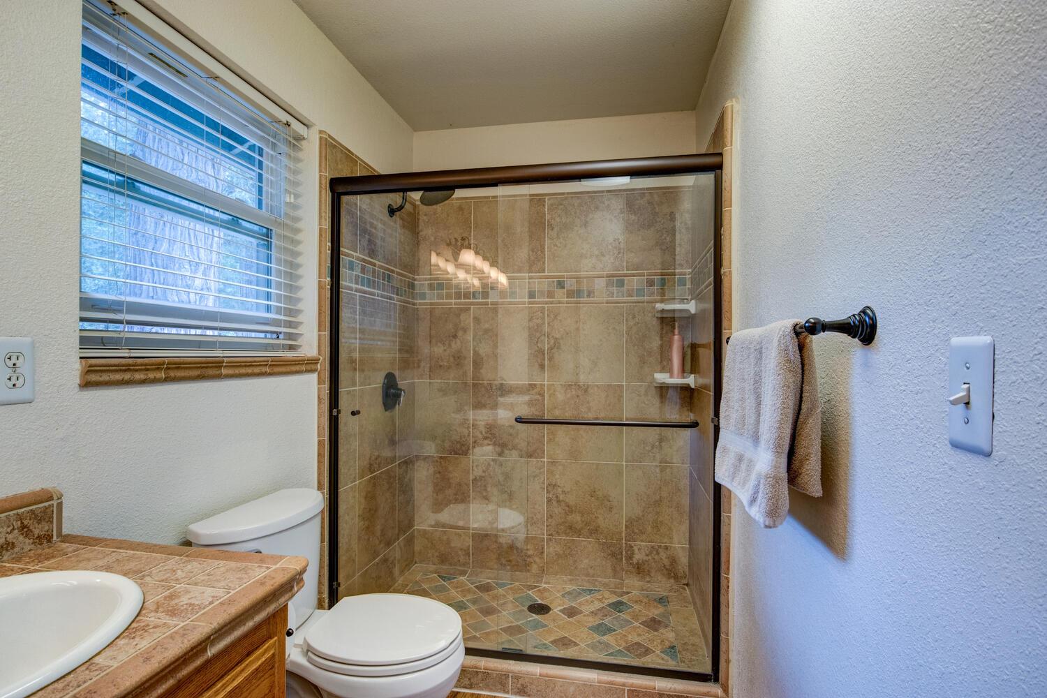 23832 Old Madrone Road Pioneer, CA 95666 - Photo 27 of 48 a bathroom with a granite countertop bathtub shower sink mirror and toilet