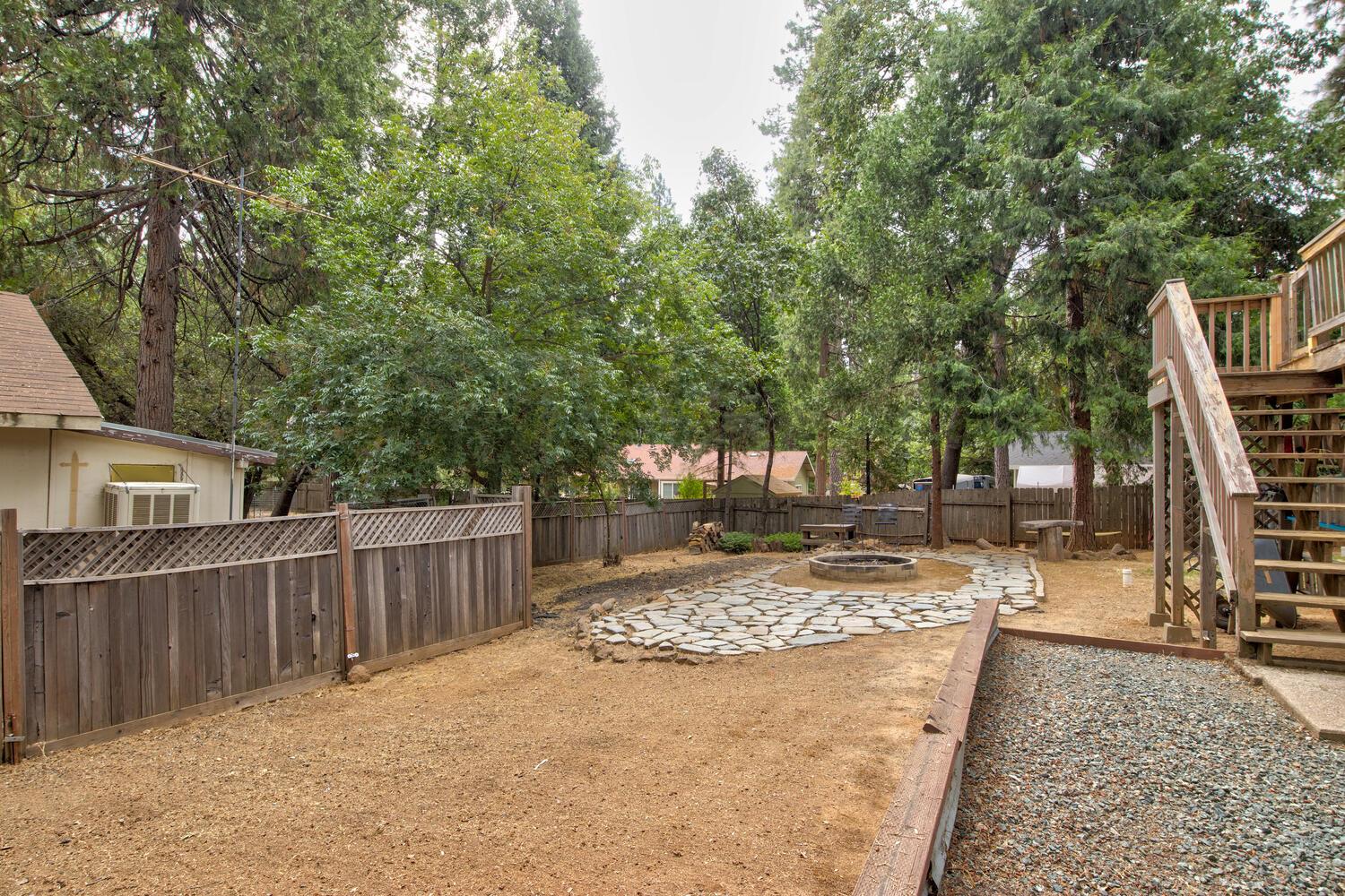 23832 Old Madrone Road Pioneer, CA 95666 - Photo 29 of 48 a view of a backyard with wooden fence and large trees