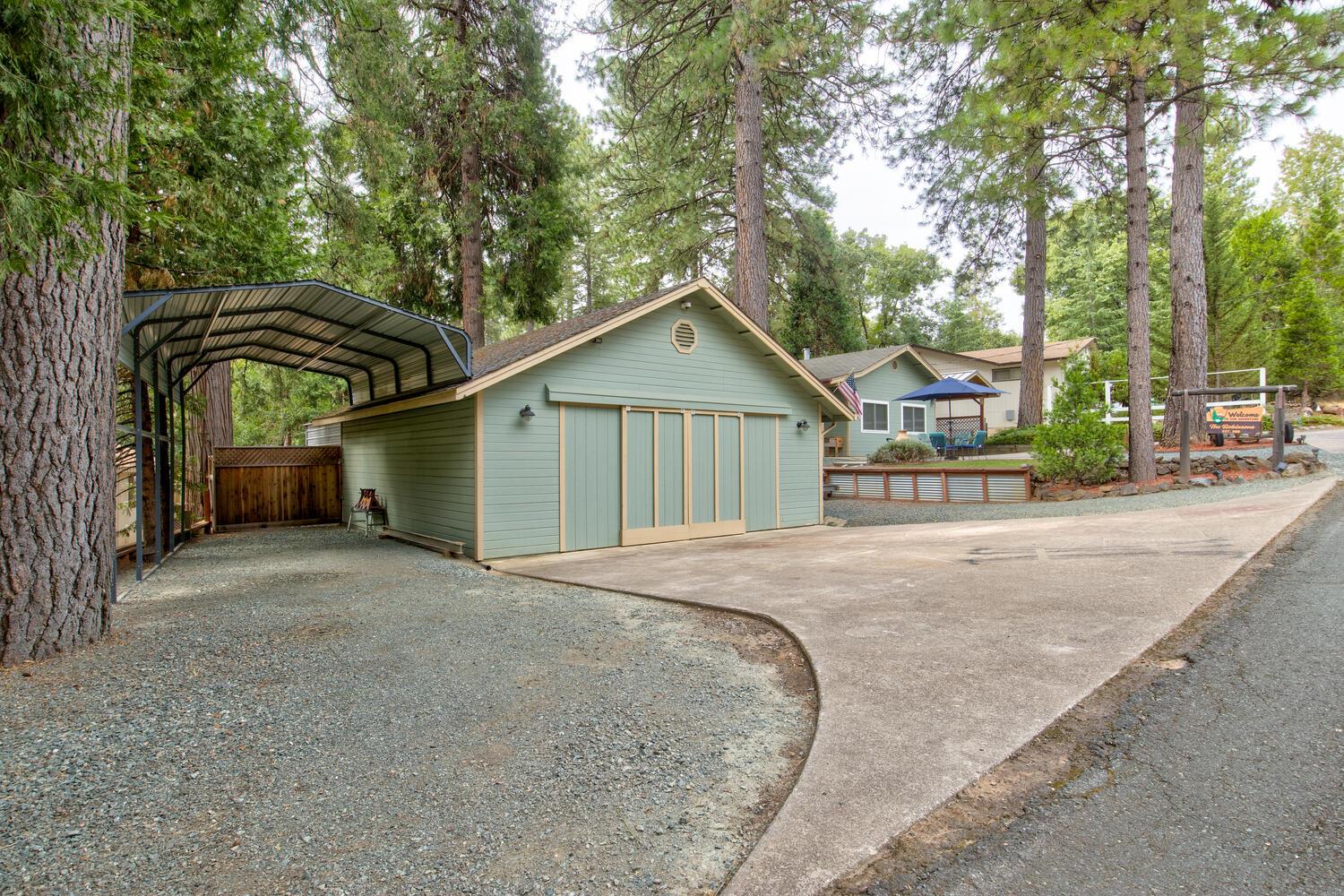 23832 Old Madrone Road Pioneer, CA 95666 - Photo 37 of 48 a front view of a house with a garden and trees