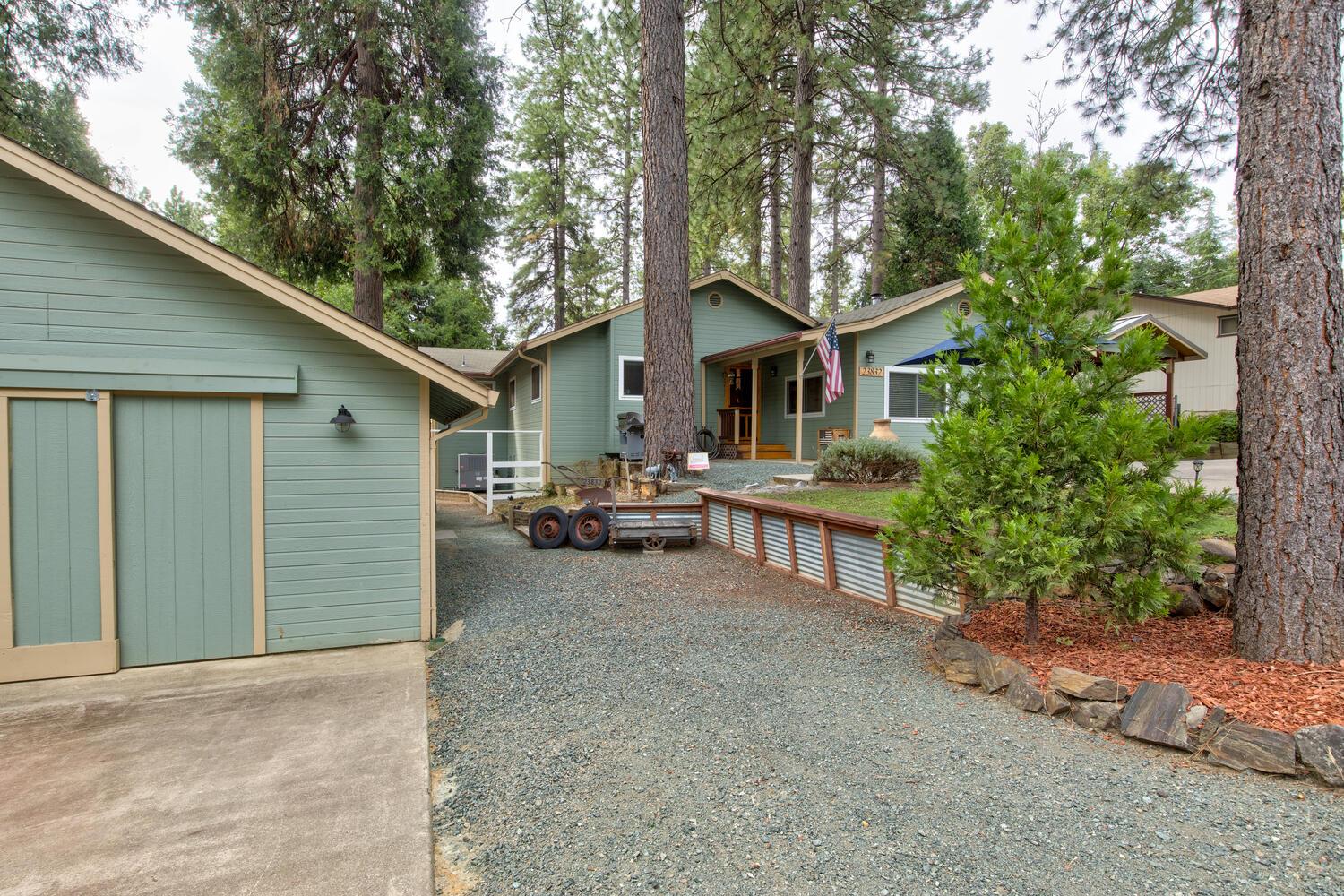 23832 Old Madrone Road Pioneer, CA 95666 - Photo 40 of 48 a view of a house with a patio and a yard