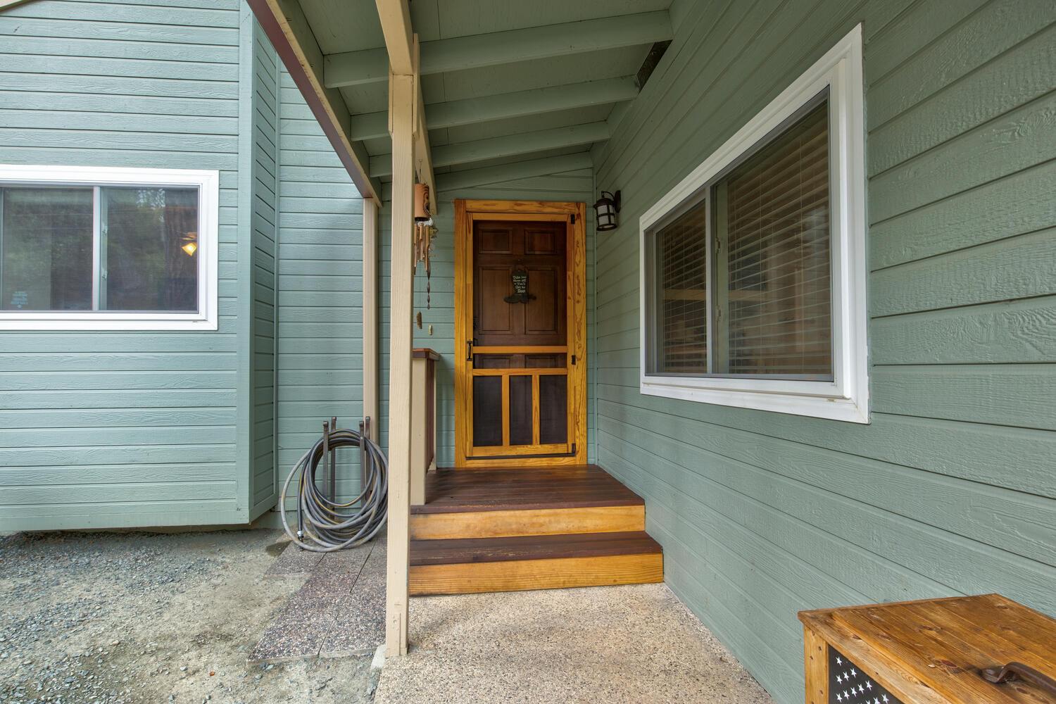 23832 Old Madrone Road Pioneer, CA 95666 - Photo 5 of 48 a front view of a house with a chair and table