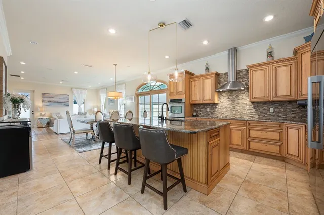 a kitchen with a dining table chairs and view living room