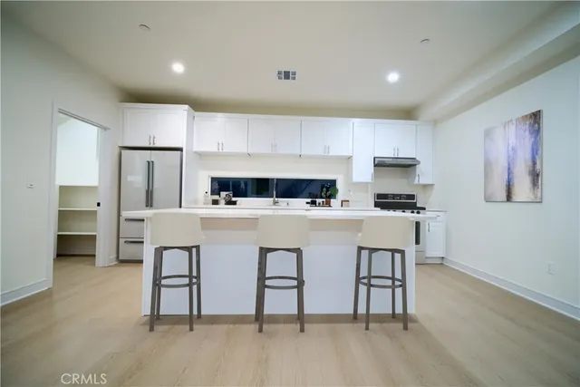 a kitchen with cabinets and appliances