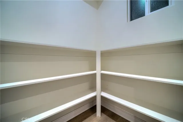 a bedroom with a bed and a potted plant